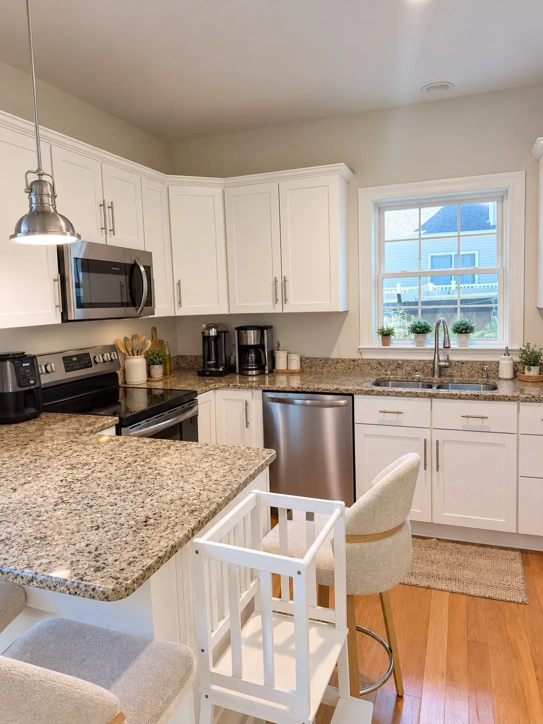 Completed CRC kitchen with white cabinets and granite countertops